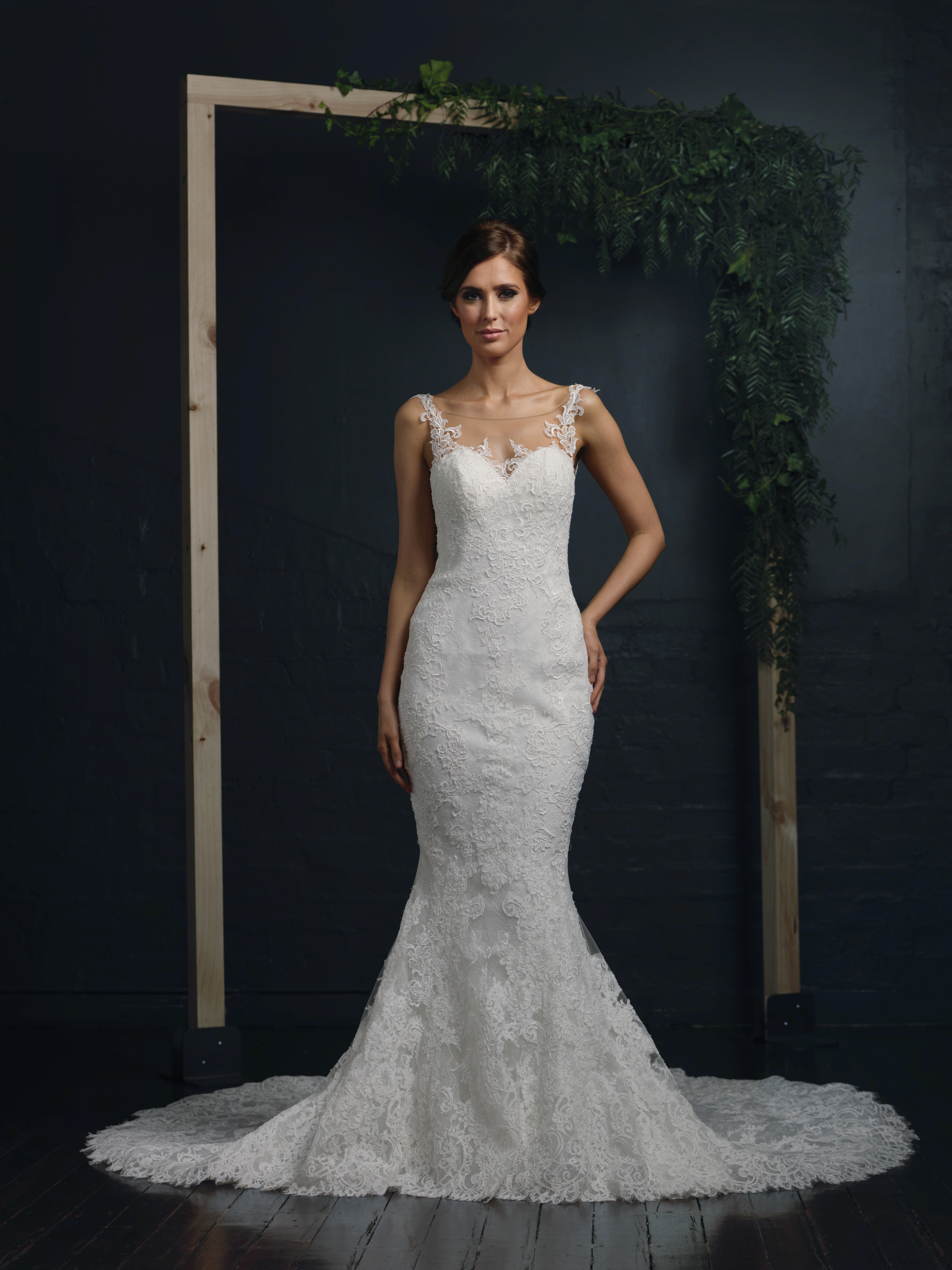 A bride wearing a lace wedding dress with a train and lace back detail in Melbourne.